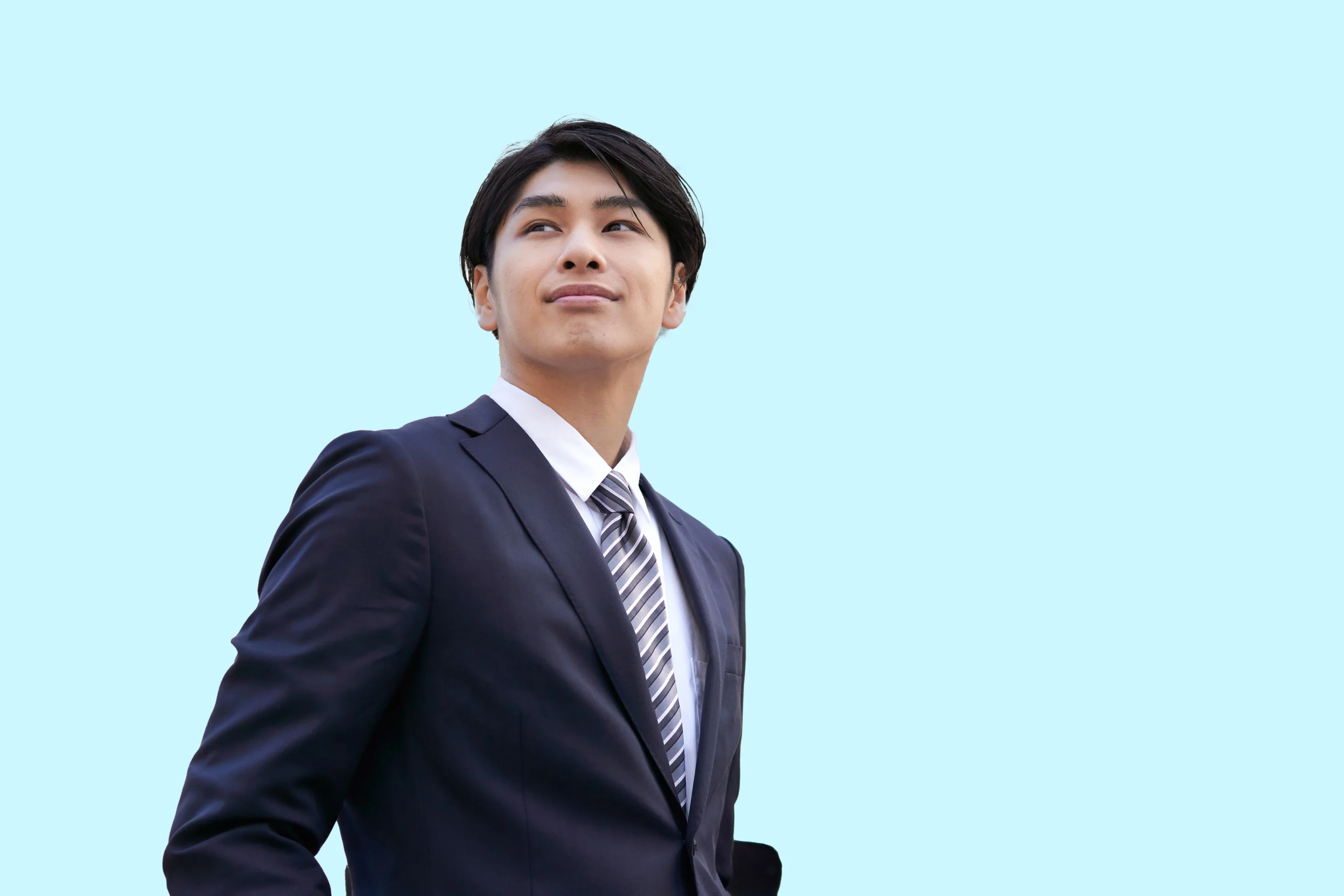 a-smiling-japanese-businessman-stands-against-a-ba-2023-11-27-05-18-09-utc2-scaled.webp
